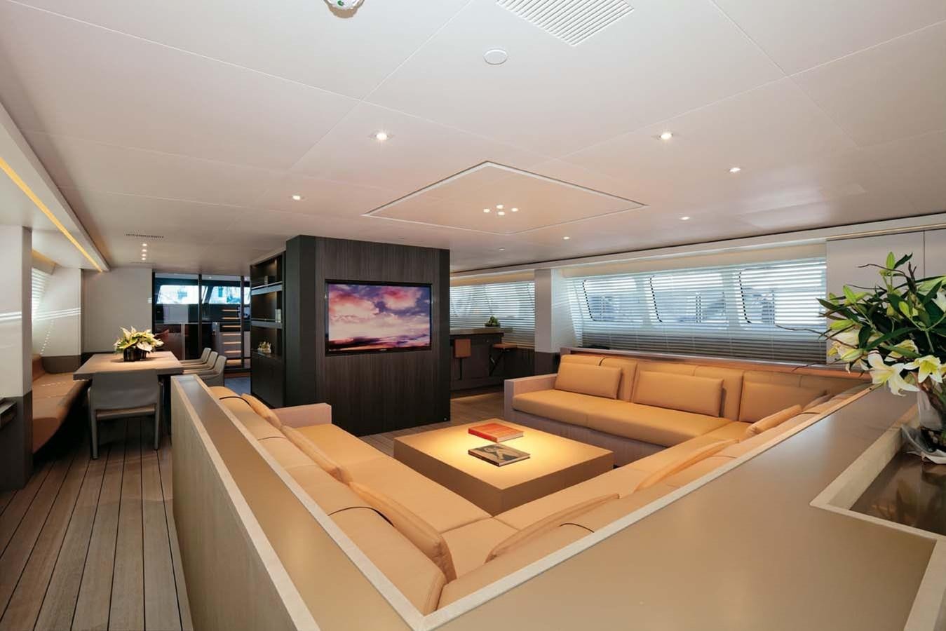 a room with a couch and a tv on the wall aboard ENTERPRISE Yacht for Sale