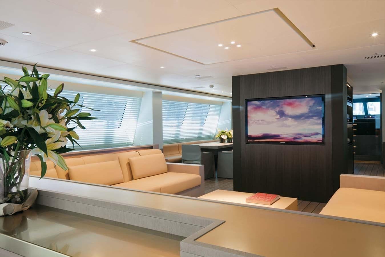 a room with a tv and couches aboard ENTERPRISE Yacht for Sale