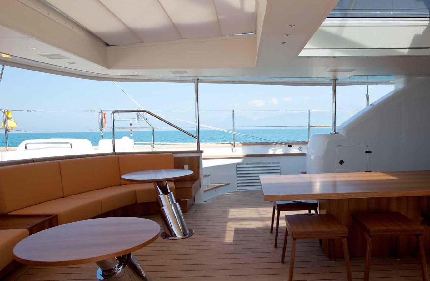 a room with tables and chairs aboard ENTERPRISE Yacht for Sale