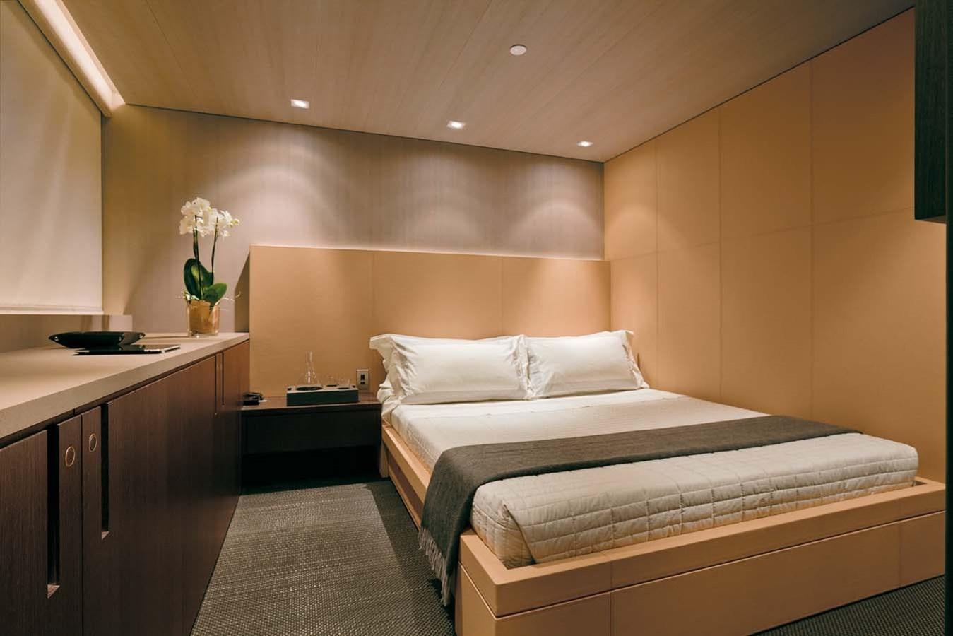 a room with a bed and desk aboard ENTERPRISE Yacht for Sale