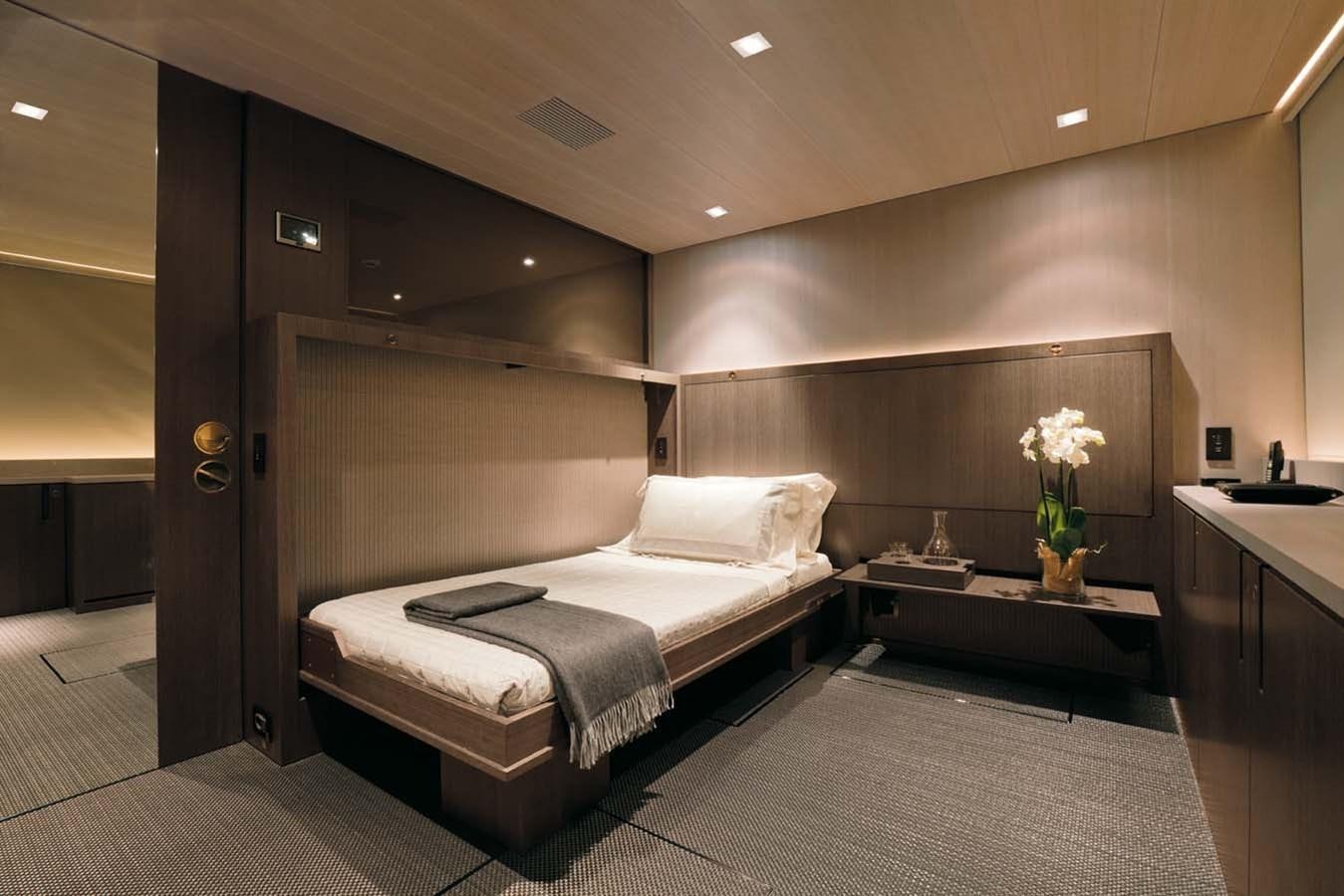 a room with a bed and desk aboard ENTERPRISE Yacht for Sale