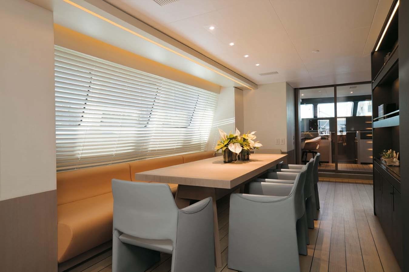 a room with a table chairs and a window aboard ENTERPRISE Yacht for Sale