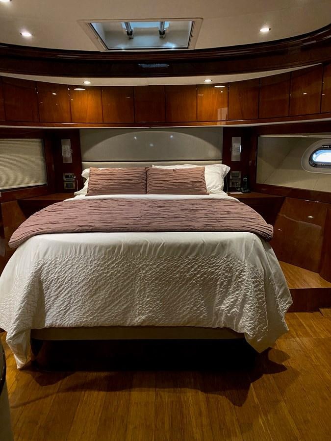 a bed with a white cover aboard SERDAL Yacht for Sale