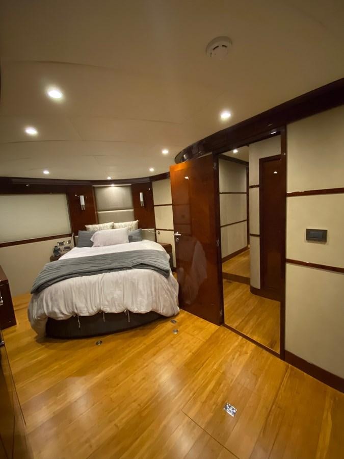 a bedroom with a wood floor aboard SERDAL Yacht for Sale