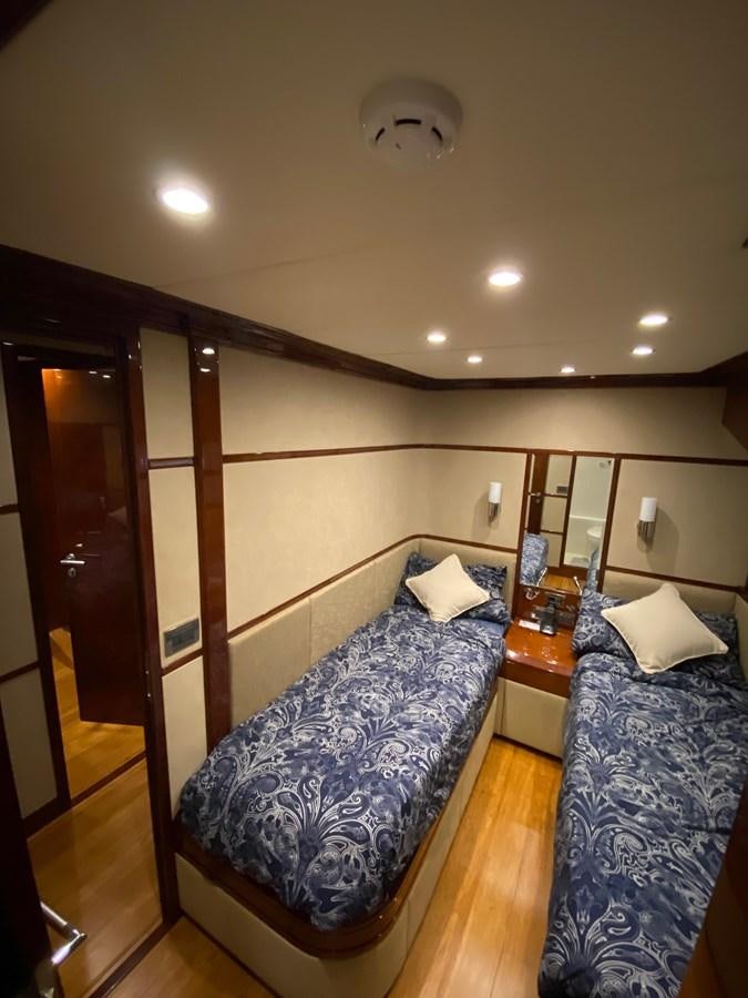 a bedroom with a bed and a desk aboard SERDAL Yacht for Sale