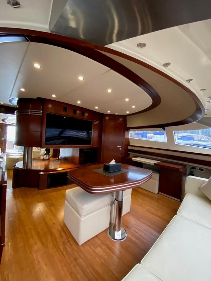 a room with a table and a tv aboard SERDAL Yacht for Sale
