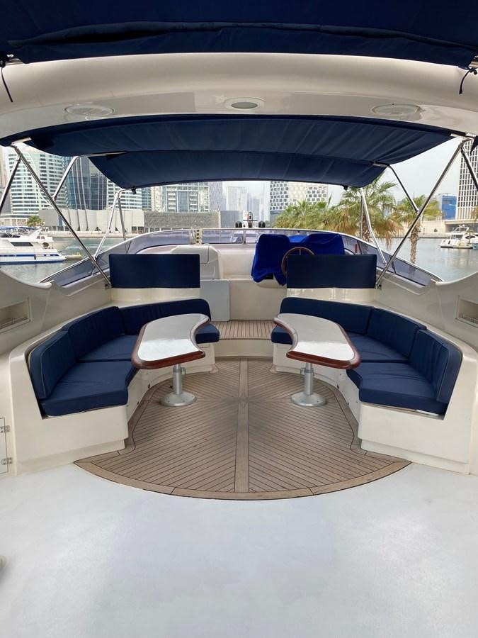 a boat with a deck and chairs aboard SERDAL Yacht for Sale