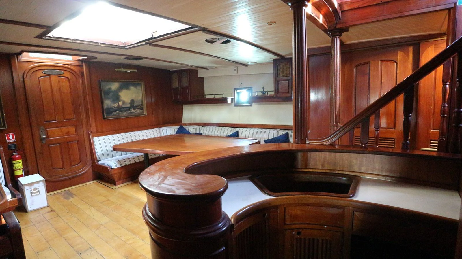 a room with a bar and a table aboard ARIES Yacht for Sale