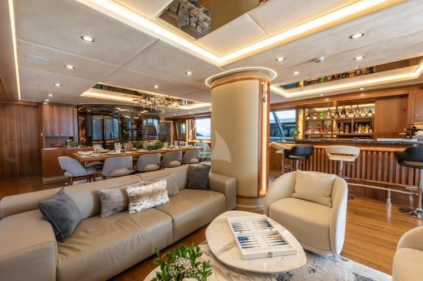 a living room with a large sofa aboard ARESTEAS Yacht for Sale