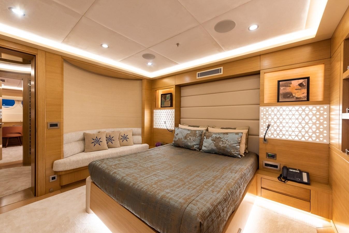 a bedroom with a bed and a desk aboard ARESTEAS Yacht for Sale