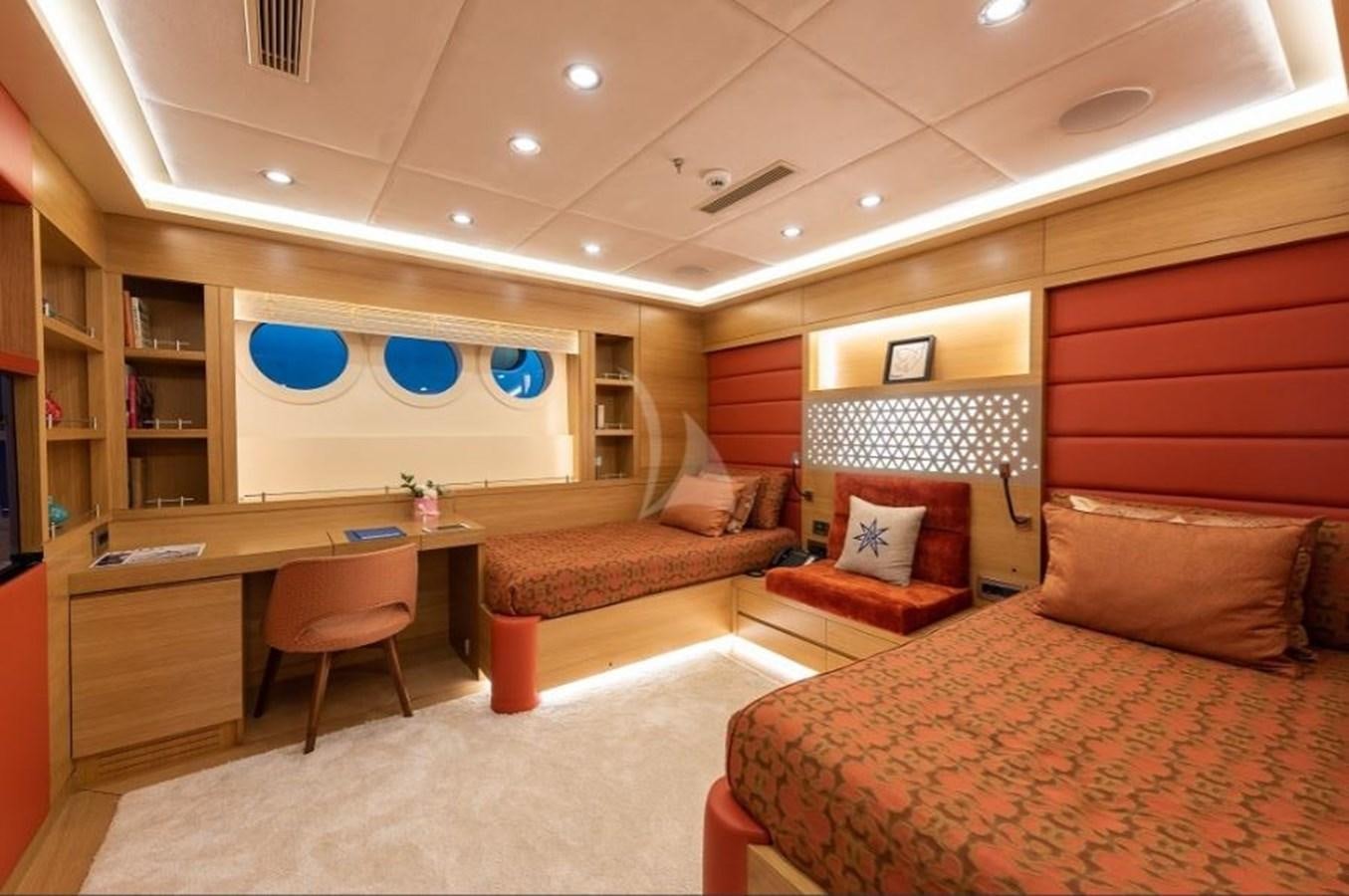 a room with a bed and a desk aboard ARESTEAS Yacht for Sale