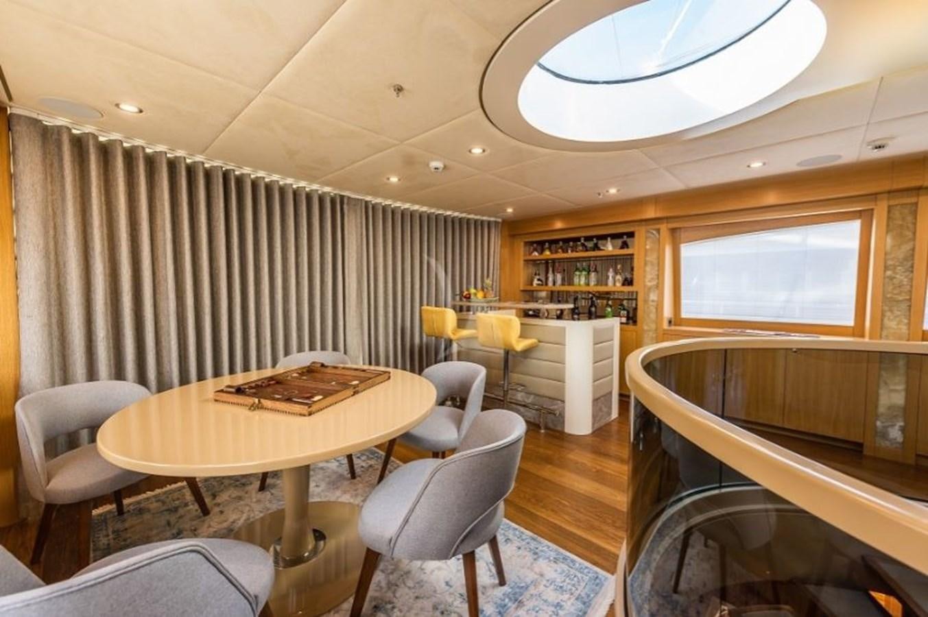 a room with a table and chairs aboard ARESTEAS Yacht for Sale