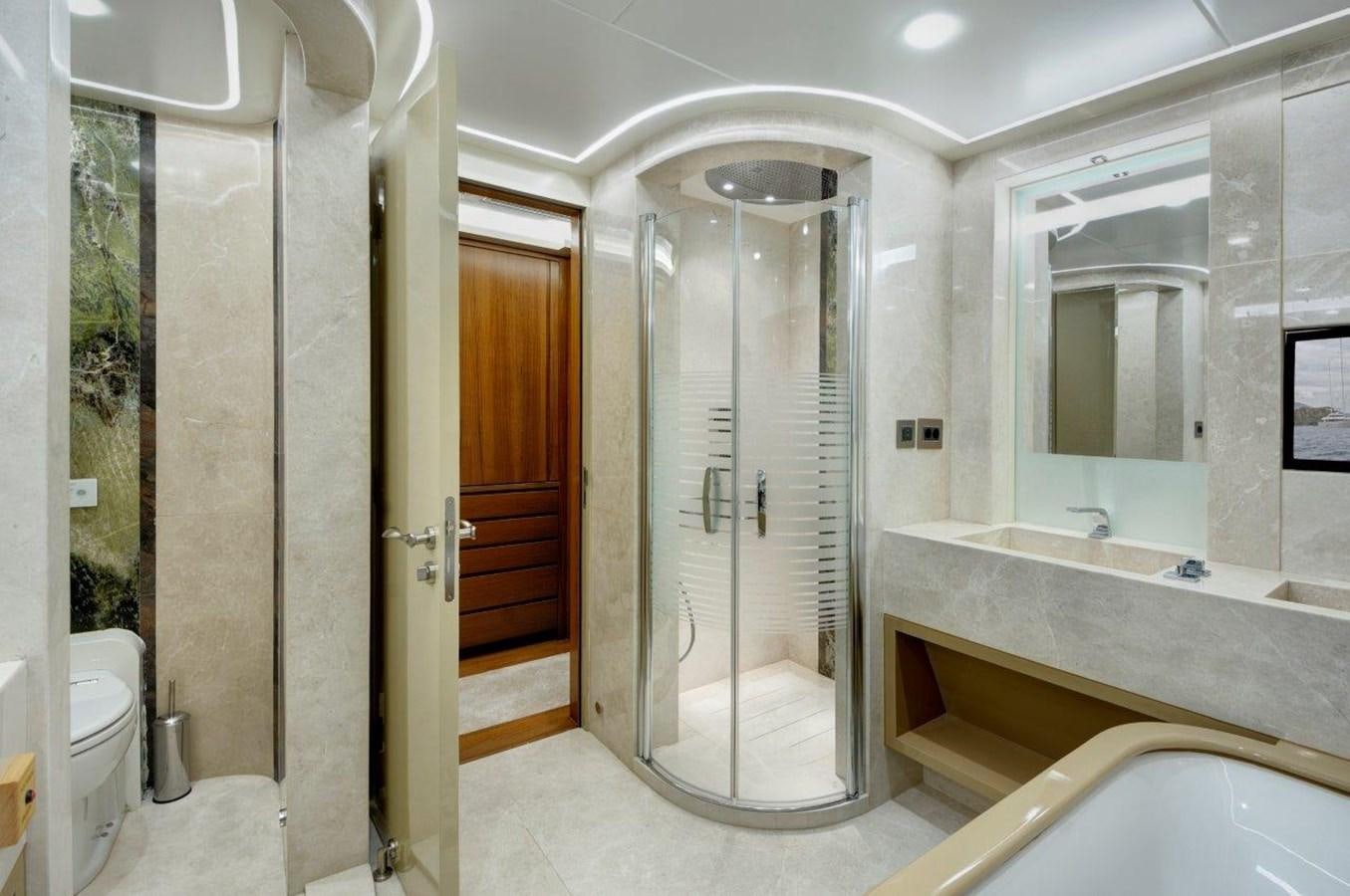a bathroom with a glass shower aboard ARESTEAS Yacht for Sale