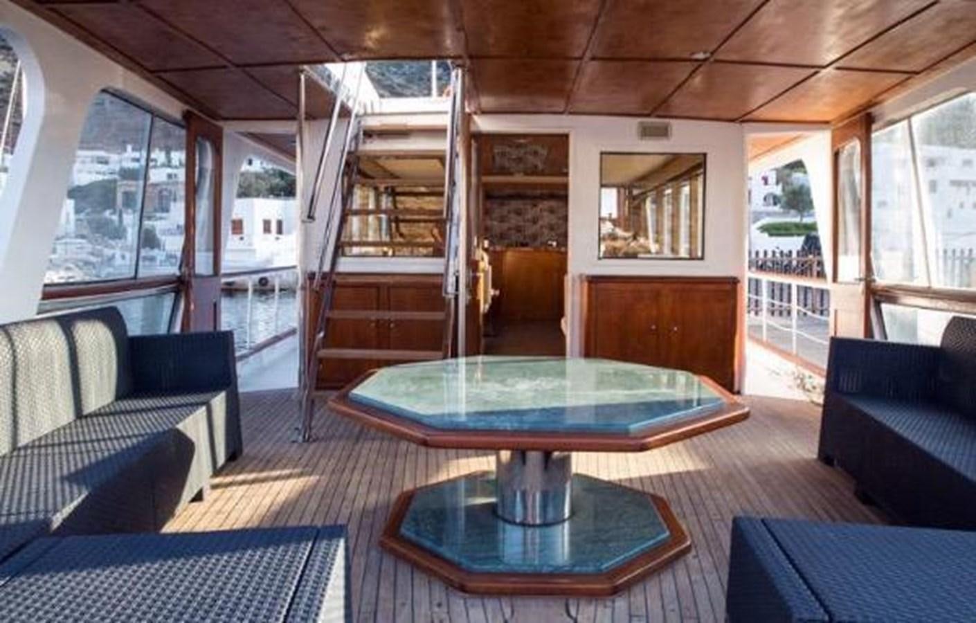 a table and chairs in a room aboard 1960 CUSTOM CRUISER  Yacht for Sale