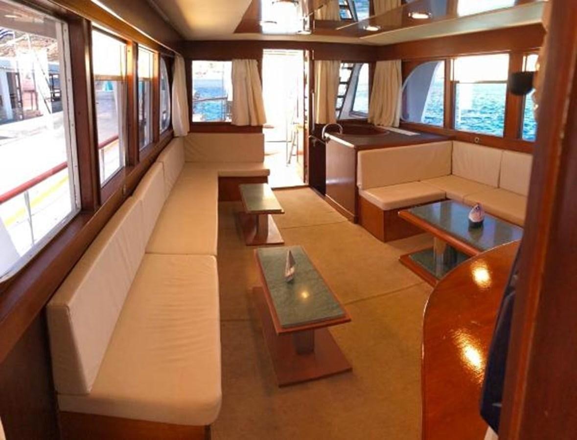 a room with a table and chairs aboard 1960 CUSTOM CRUISER  Yacht for Sale