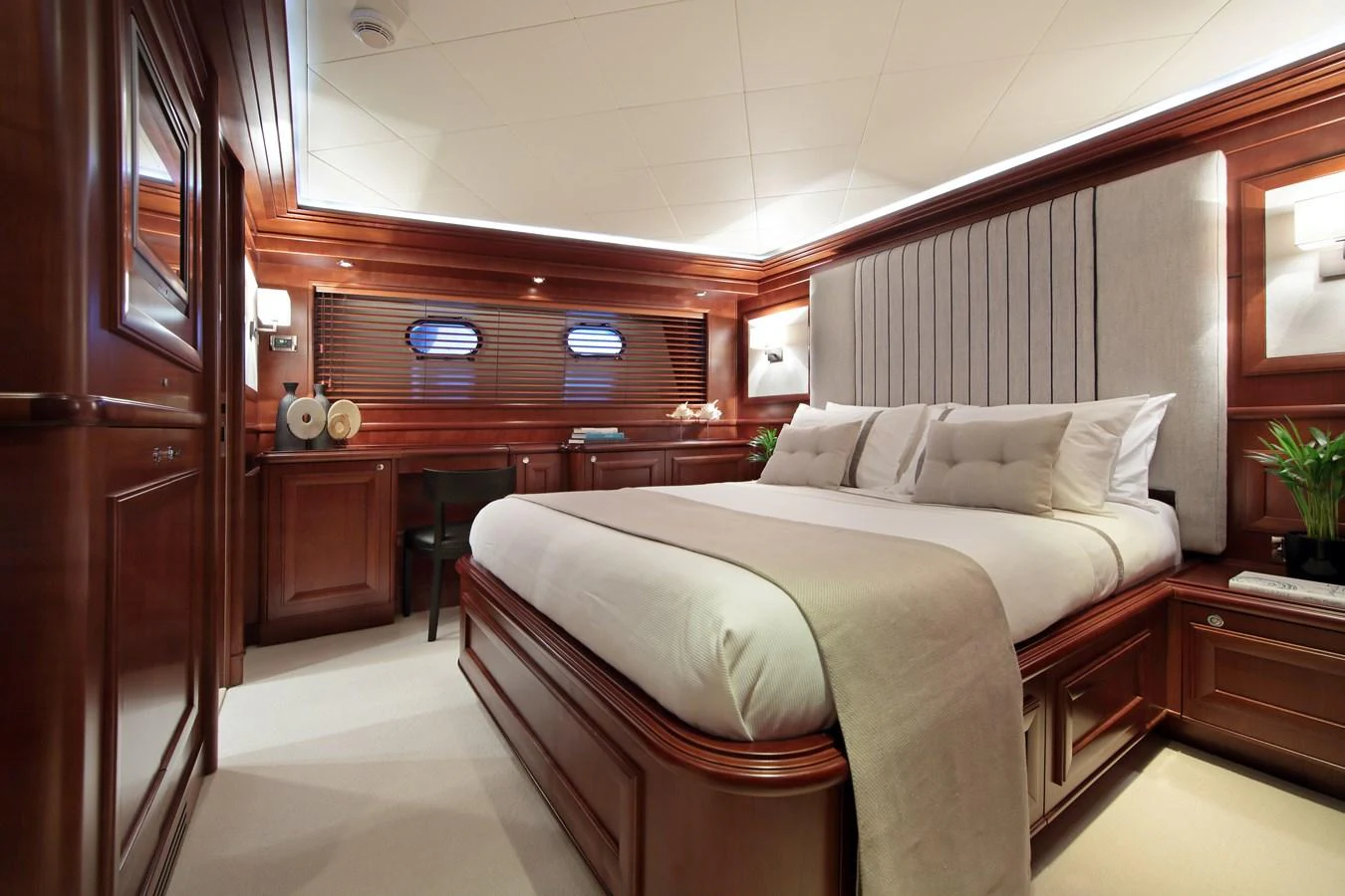 a bedroom with a bed and desk aboard LADY SOUL Yacht for Charter