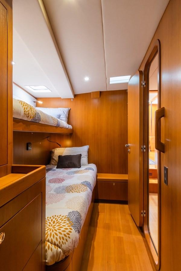 a bedroom with a bed and a closet aboard SHADOW Yacht for Sale