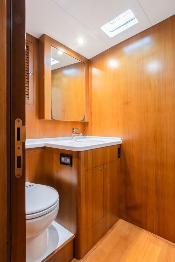 a bathroom with a toilet and a sink aboard SHADOW Yacht for Sale