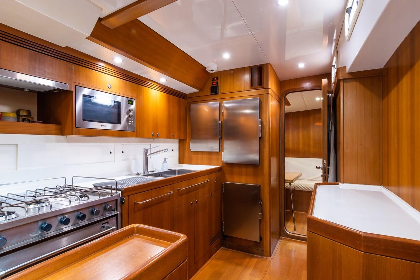 a kitchen with wooden cabinets aboard SHADOW Yacht for Sale