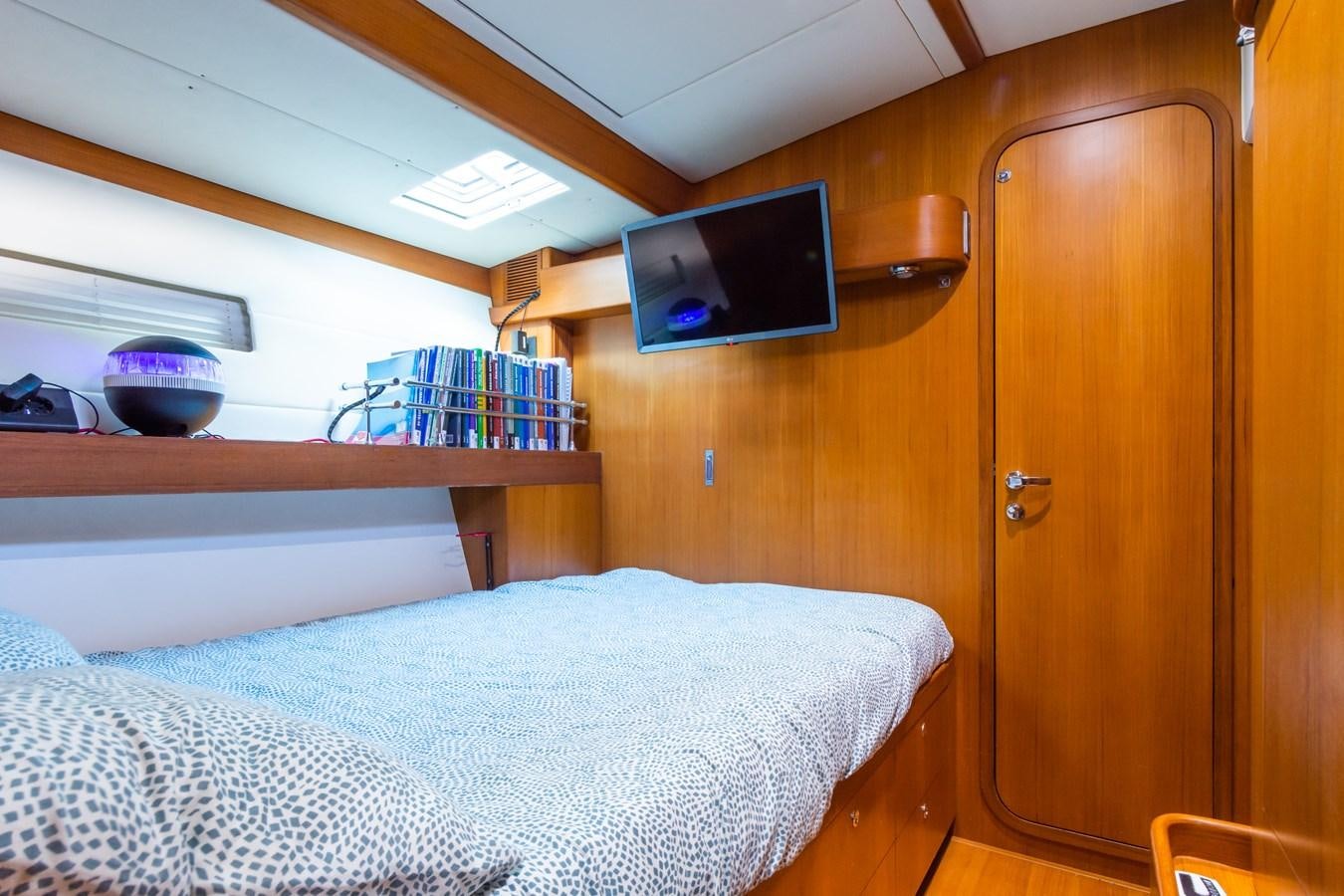 a bedroom with a bed and a television aboard SHADOW Yacht for Sale