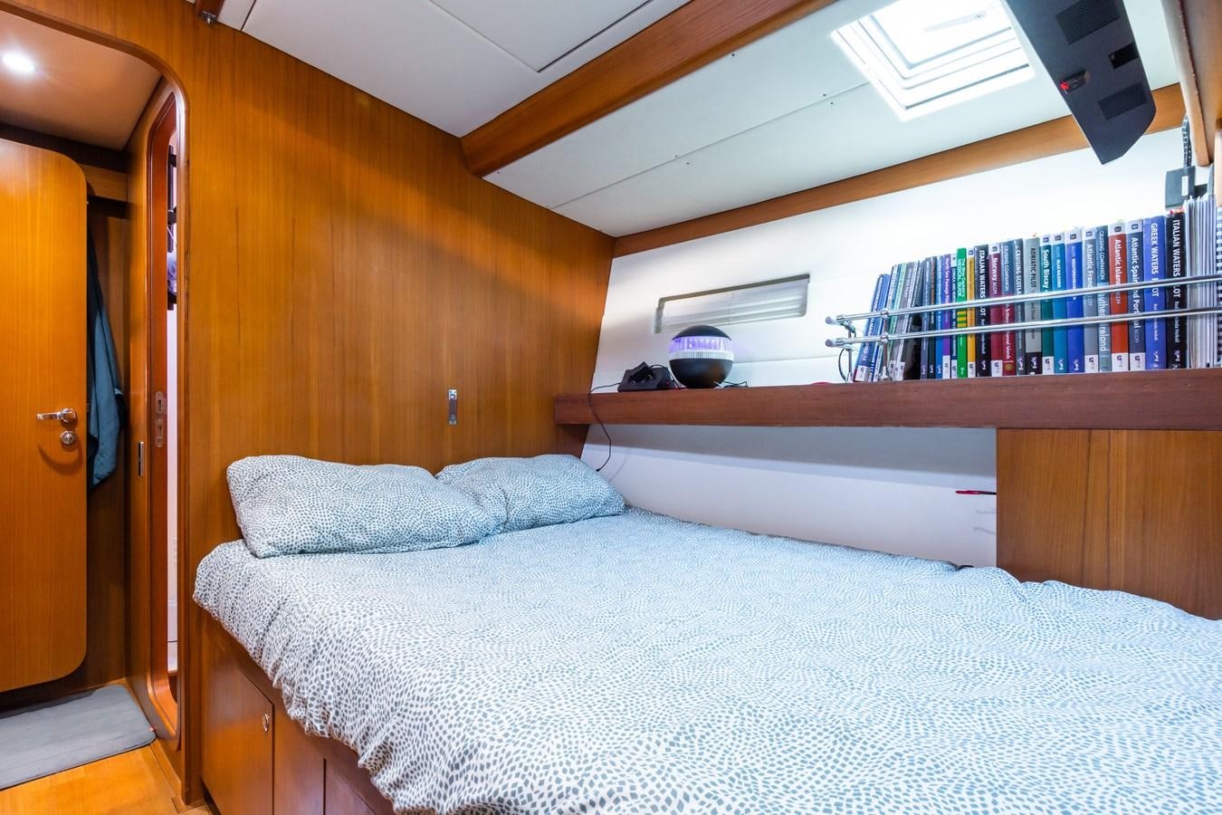 a bed with a white sheet aboard SHADOW Yacht for Sale