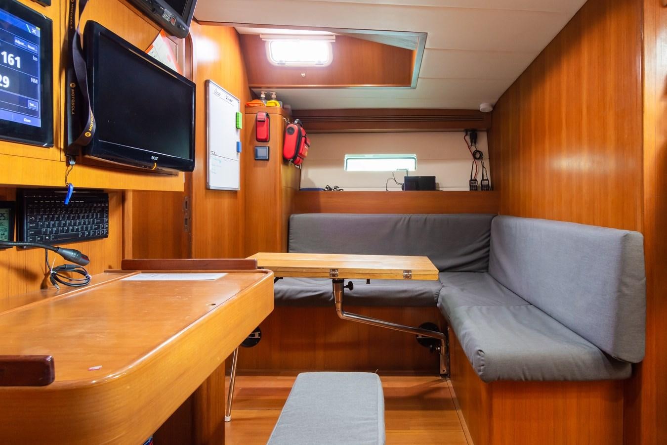 a room with a couch and a tv aboard SHADOW Yacht for Sale