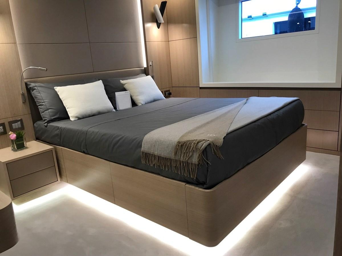 a bed with a black and white bed spread aboard ALEGRE Yacht for Charter