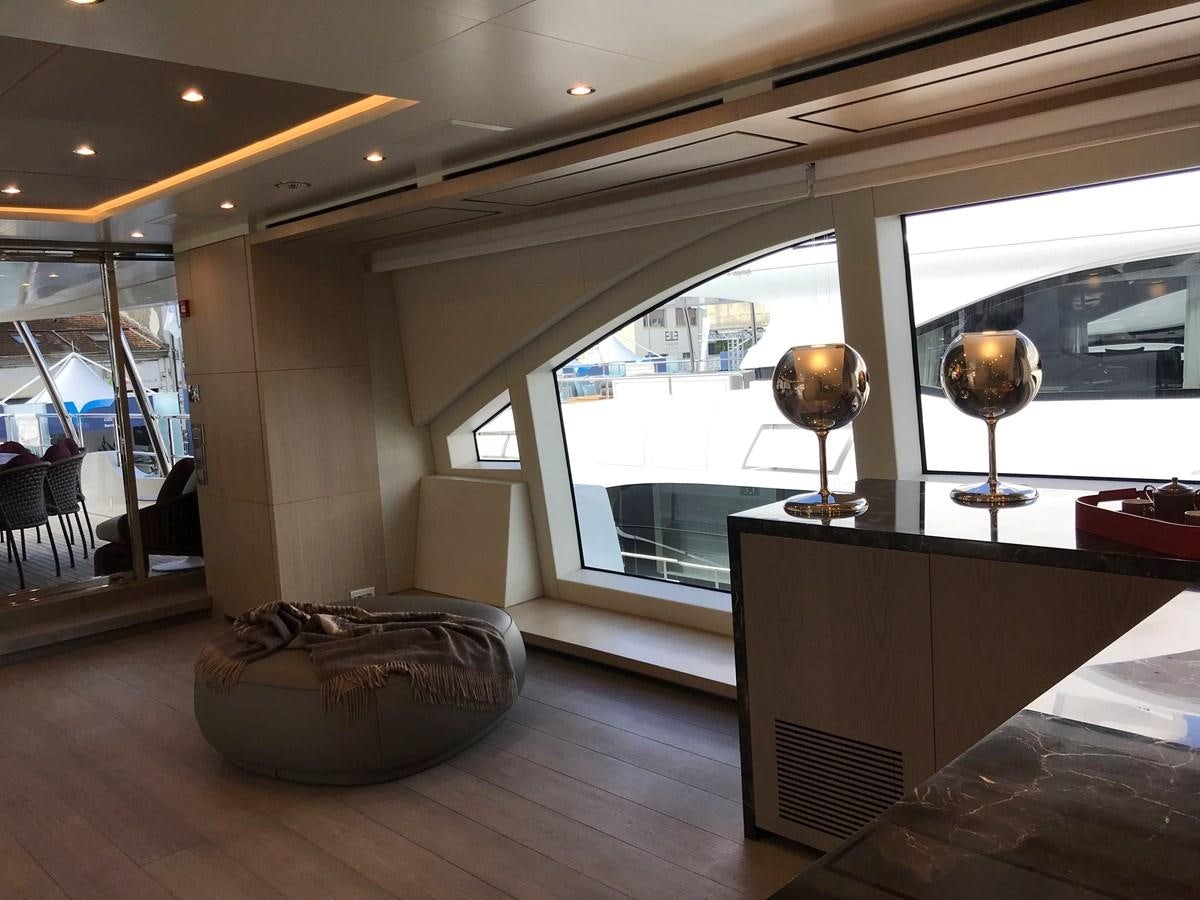 a room with a large window and a table with a lamp on it aboard ALEGRE Yacht for Charter