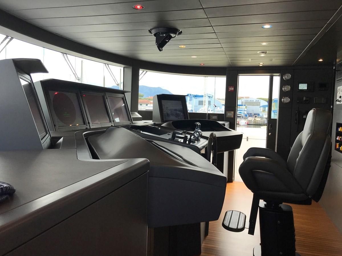 a room with a large window and a desk with computers on it aboard ALEGRE Yacht for Charter