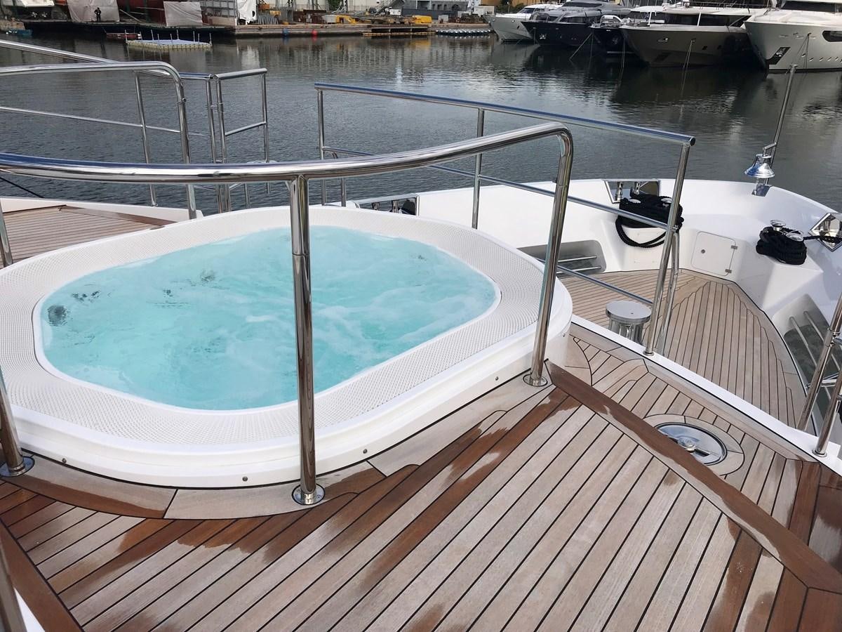 a deck with a pool and a deck with a deck and a large building in the background aboard ALEGRE Yacht for Charter
