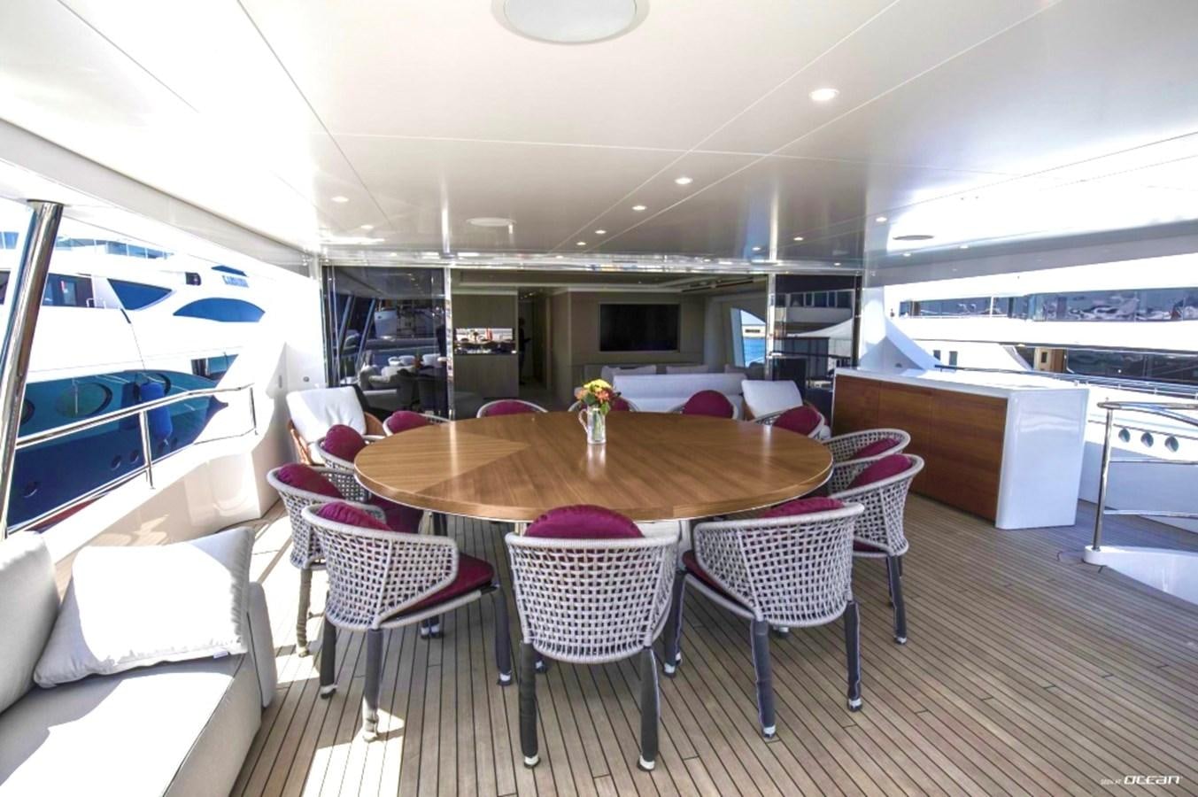 a dining table and chairs in a room with a large window aboard ALEGRE Yacht for Charter