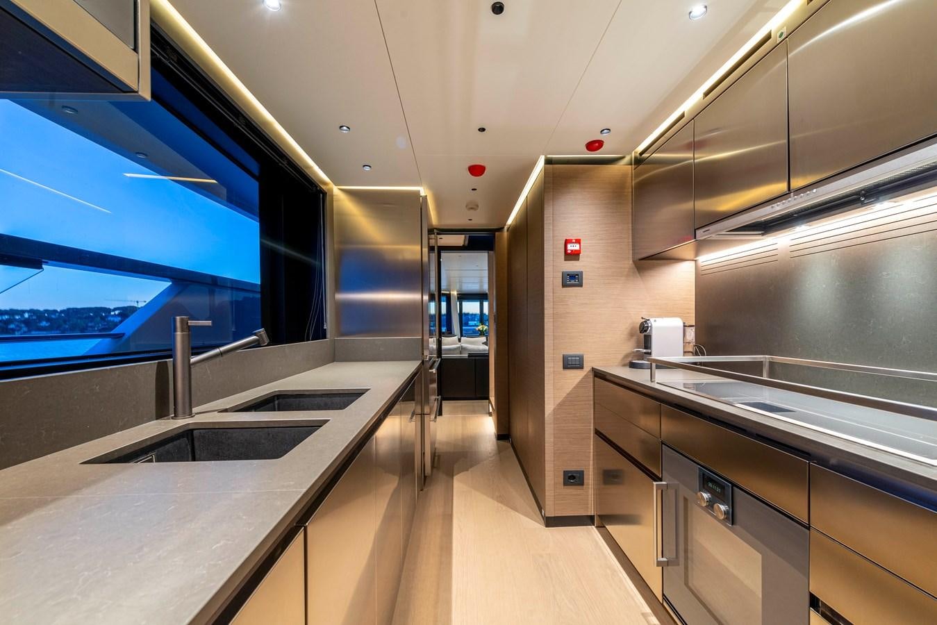 a large kitchen with stainless steel appliances aboard AMWAJ Yacht for Sale