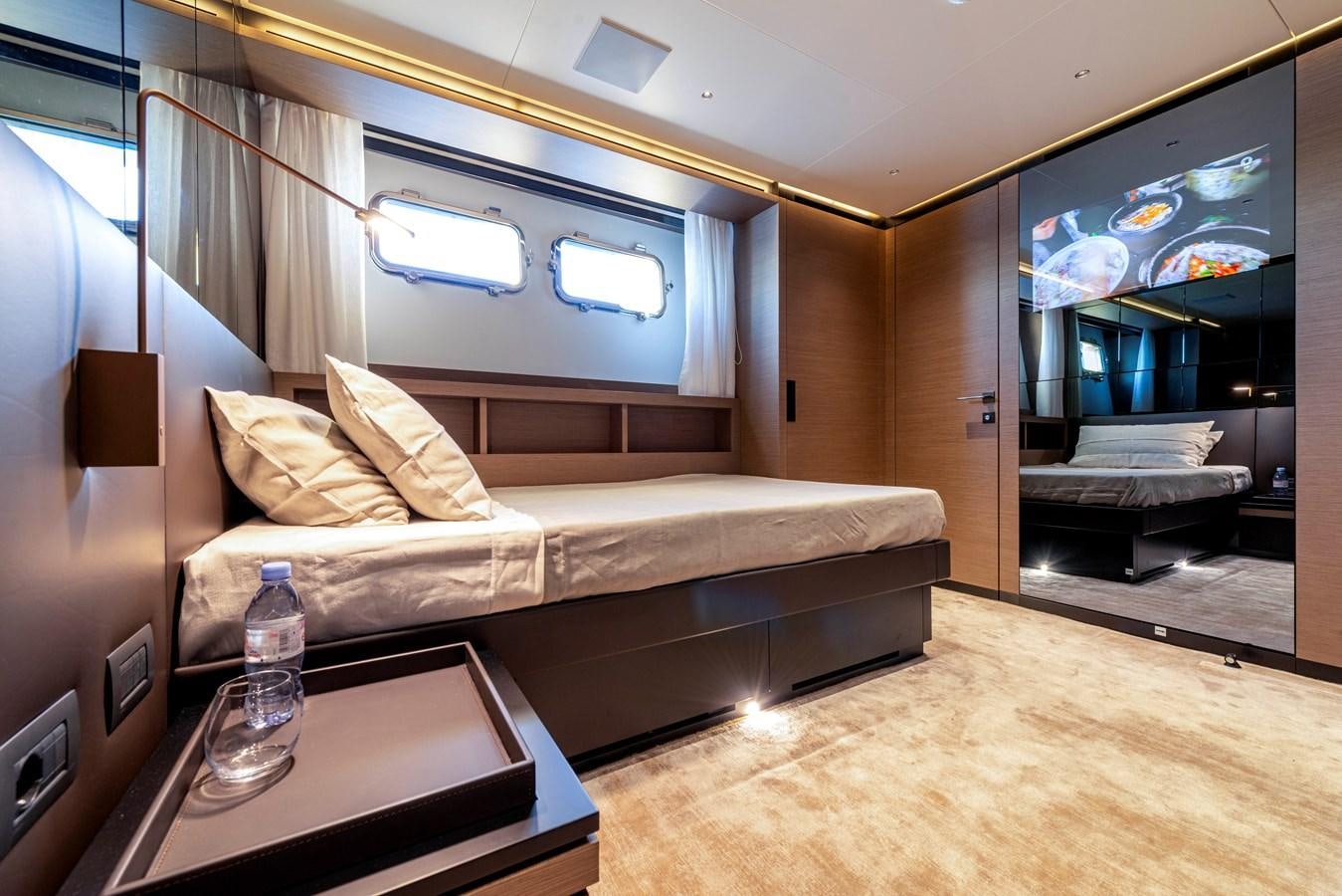 a room with a bed and a table aboard AMWAJ Yacht for Sale