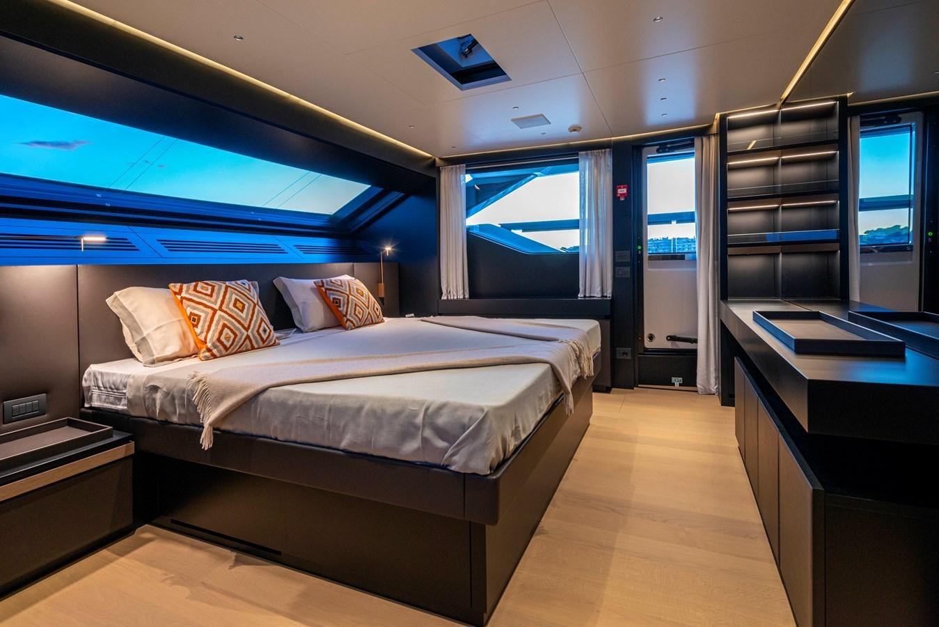 a room with a bed and a desk aboard AMWAJ Yacht for Sale