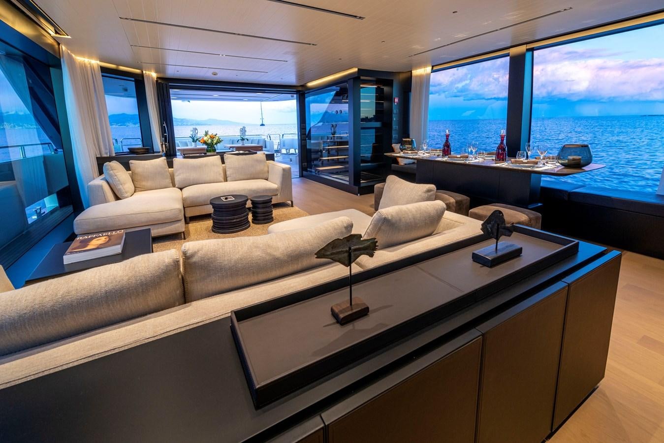 a living room with a large window aboard AMWAJ Yacht for Sale