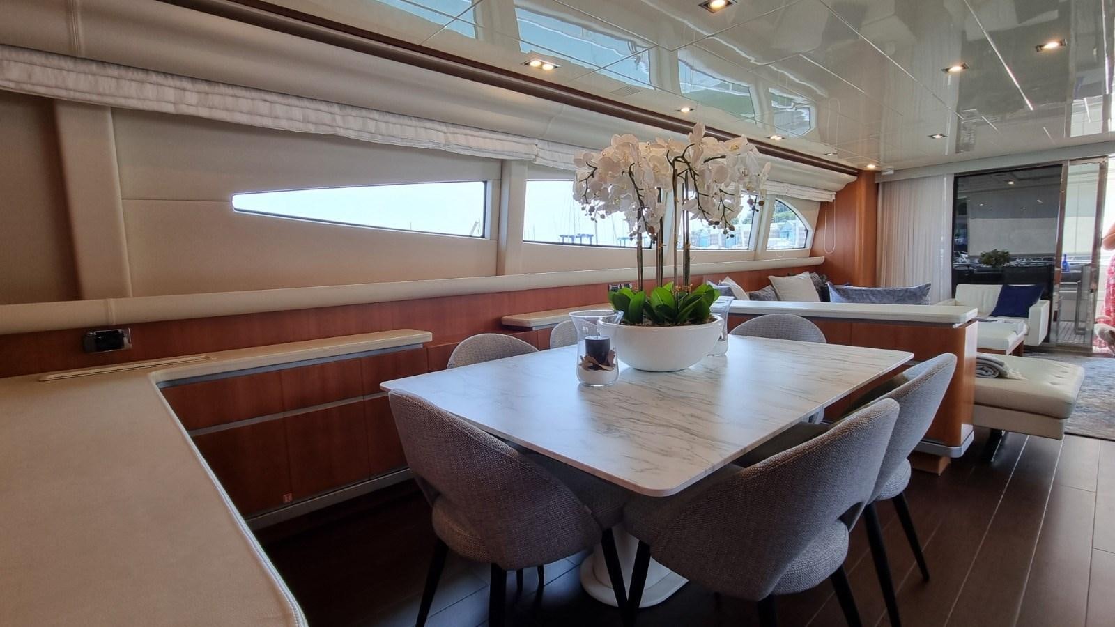 a room with tables and chairs aboard FTS2 Yacht for Sale