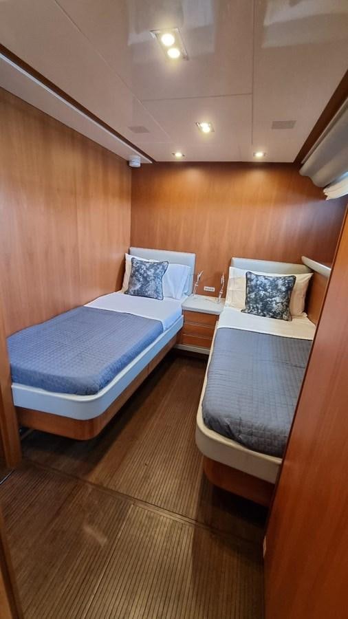 a room with a bed and a wood wall aboard FTS2 Yacht for Sale