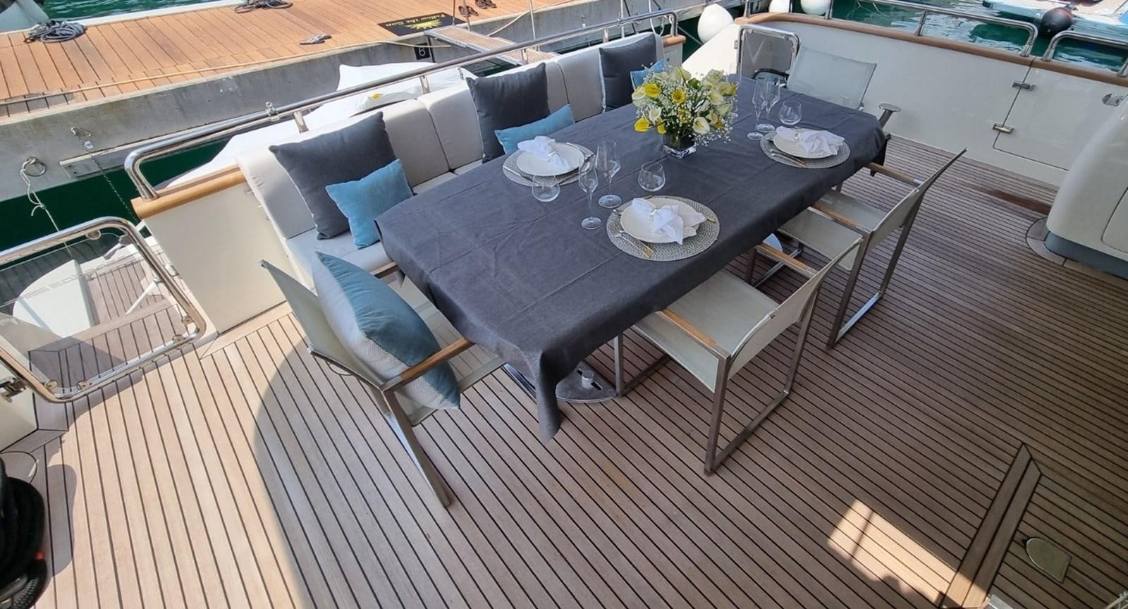 a dining table on a balcony aboard FTS2 Yacht for Sale