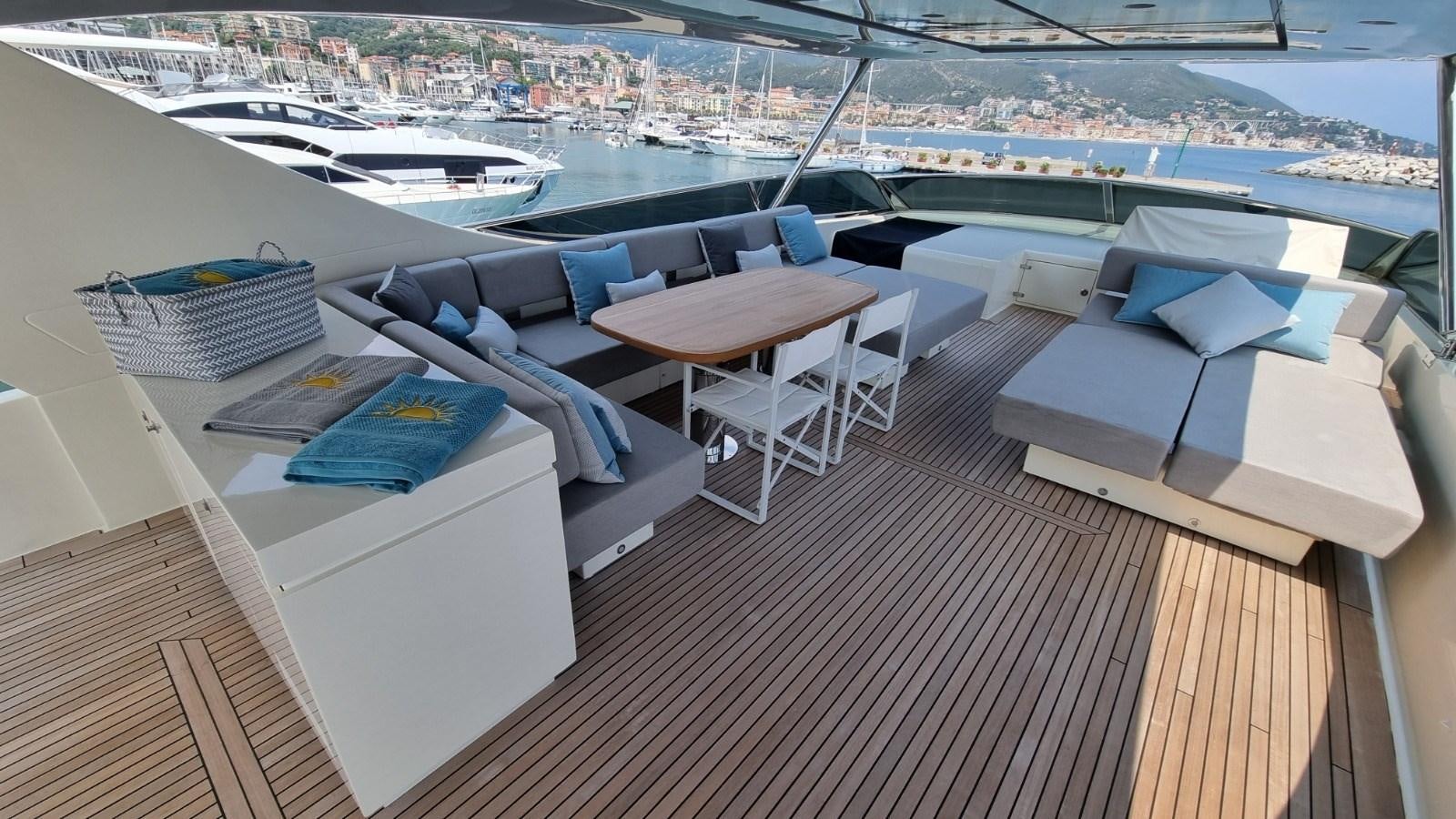 a deck with a table and chairs aboard FTS2 Yacht for Sale