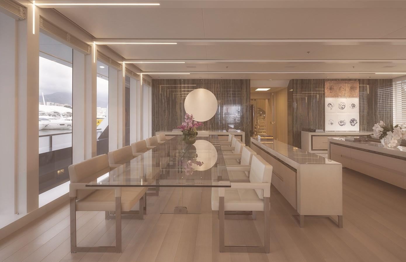 a large room with a large table and chairs aboard STELLA MARIS Yacht for Sale