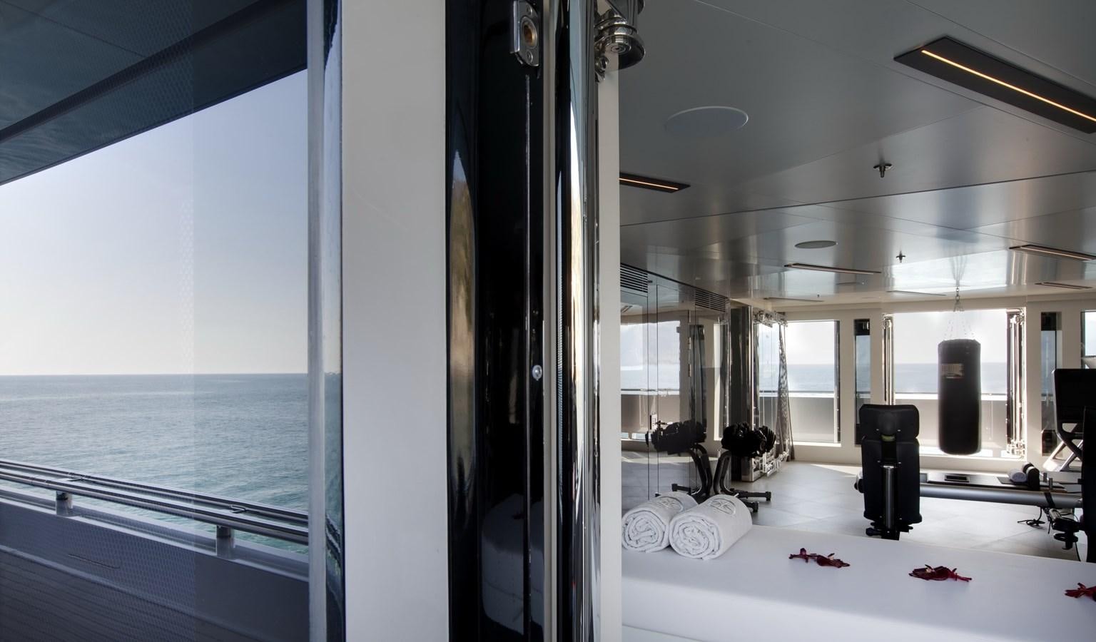 a room with a large mirror and a table with chairs aboard STELLA MARIS Yacht for Sale