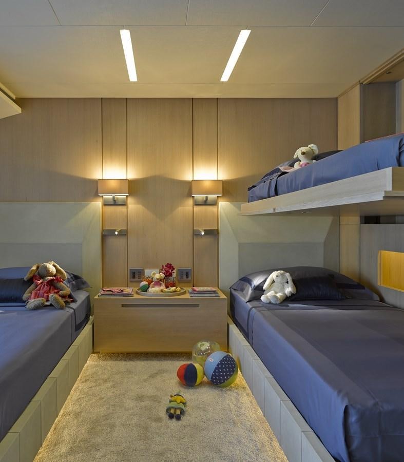 a room with bunk beds and a lamp on the wall aboard STELLA MARIS Yacht for Sale
