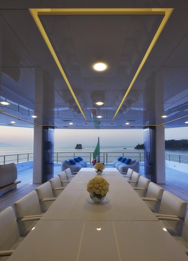 a room with a large window and a vase with flowers in it aboard STELLA MARIS Yacht for Sale