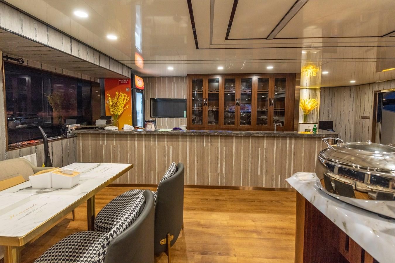 a kitchen with a table and chairs aboard INFINITY X Yacht for Sale