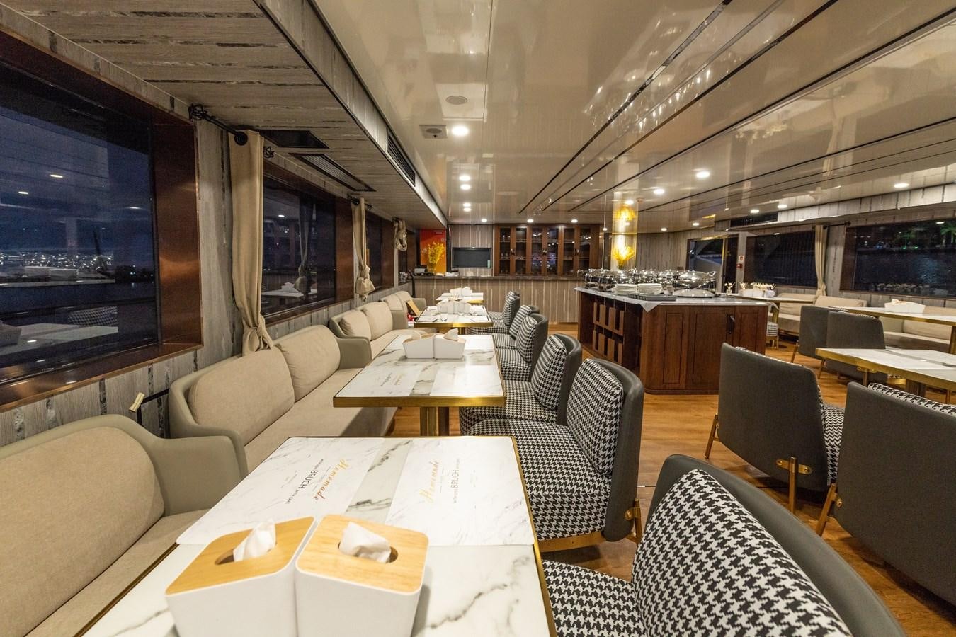 a room with a table chairs and a large window aboard INFINITY X Yacht for Sale