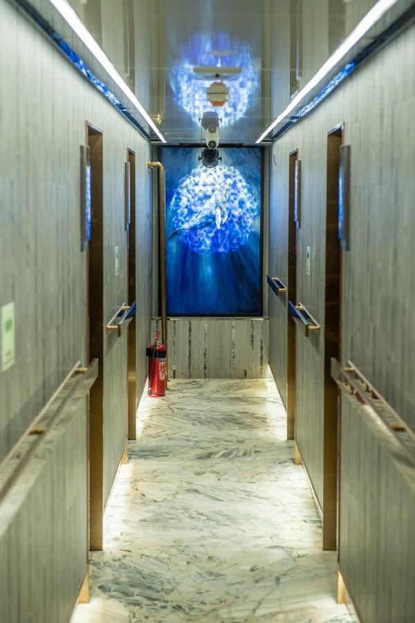 a room with a door and a light on the wall aboard INFINITY X Yacht for Sale