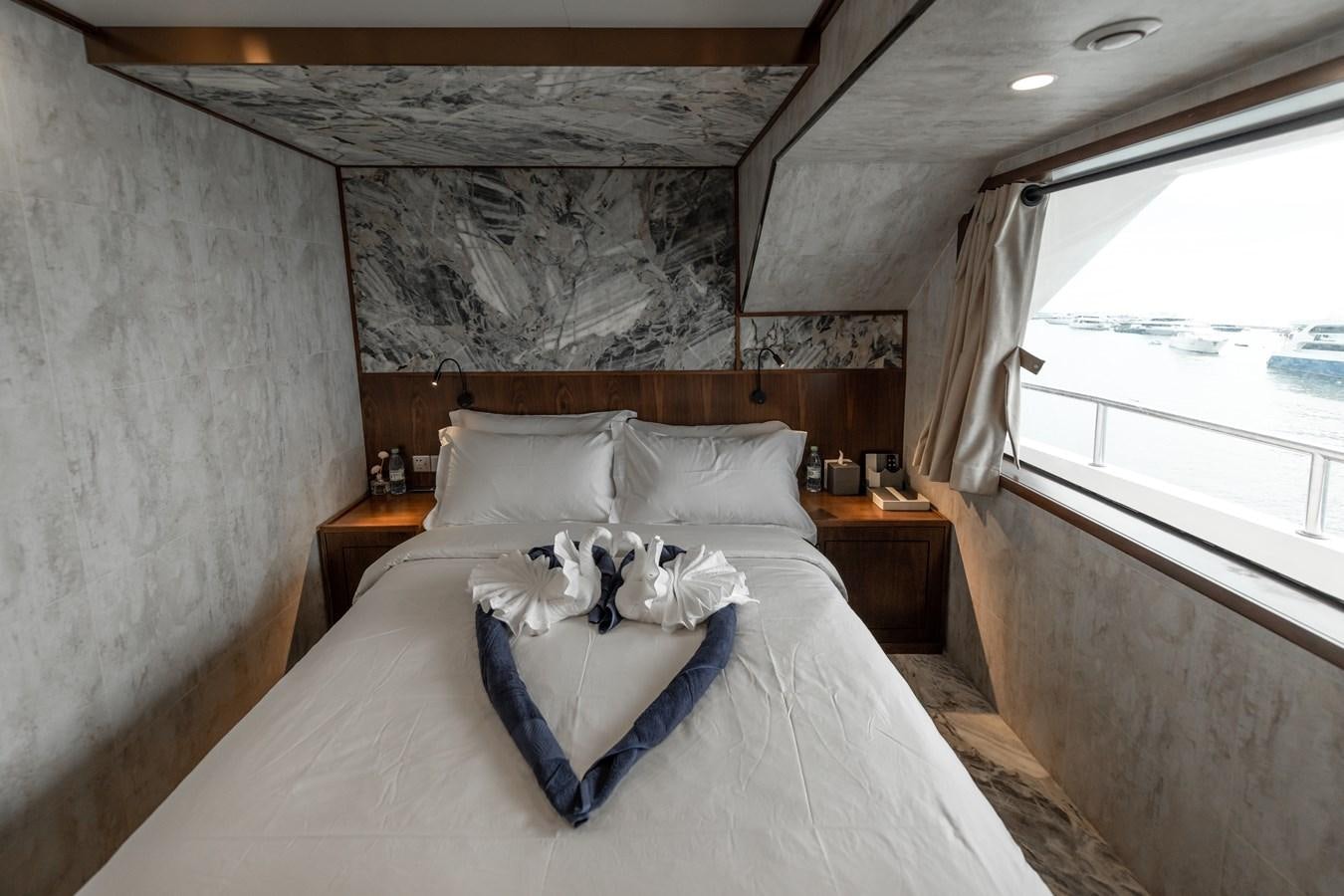 a bed with white sheets and pillows aboard INFINITY X Yacht for Sale