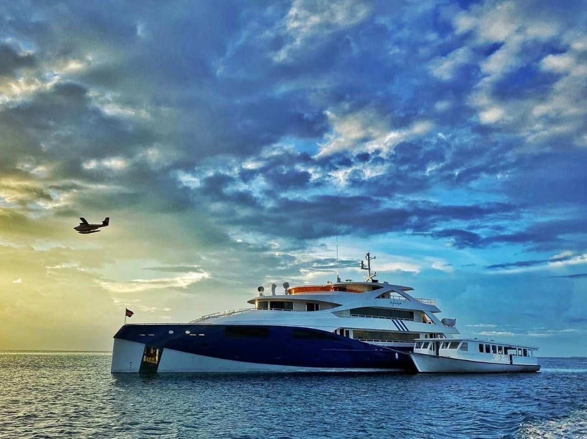 a boat in the water with a bird flying over it aboard INFINITY X Yacht for Sale