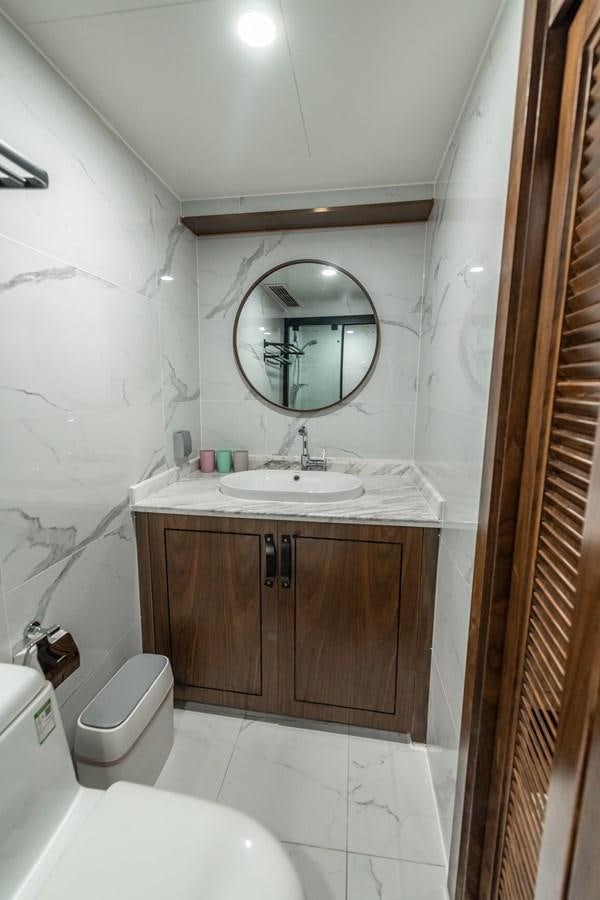 a bathroom with a sink and a toilet aboard INFINITY X Yacht for Sale