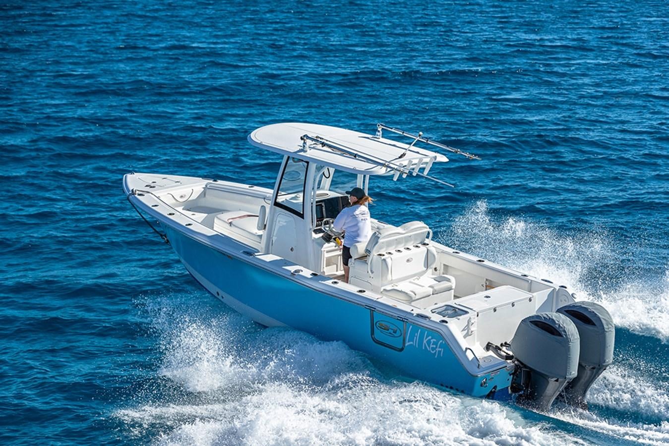 a man driving a boat aboard KEFI Yacht for Sale